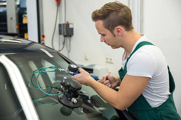 Certified technician performing windshield repair in Covina